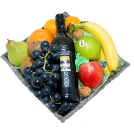 Fruit bowl with a bottle of red wine